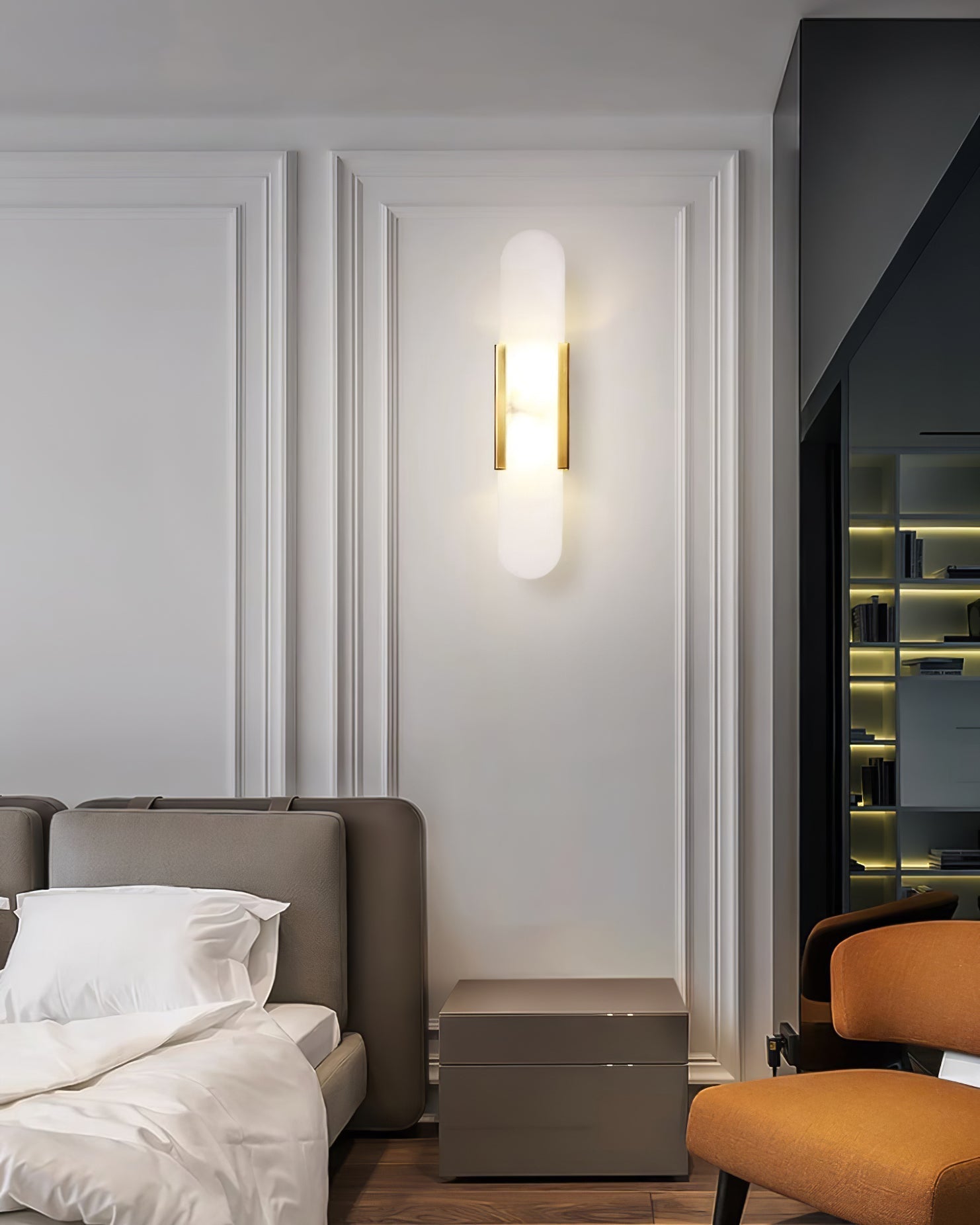 Modern alabaster wall light beside a bathroom vanity mirror