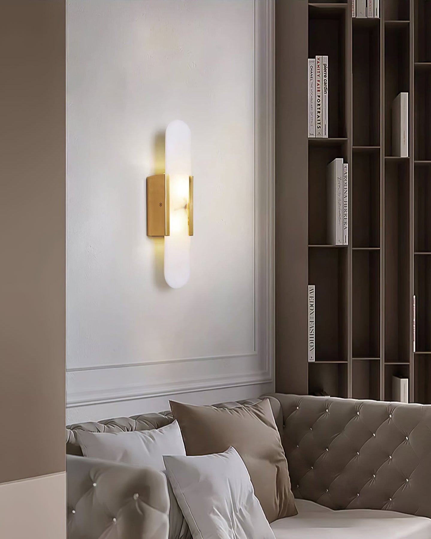 Elongated alabaster bedside wall lamp casting warm diffused light