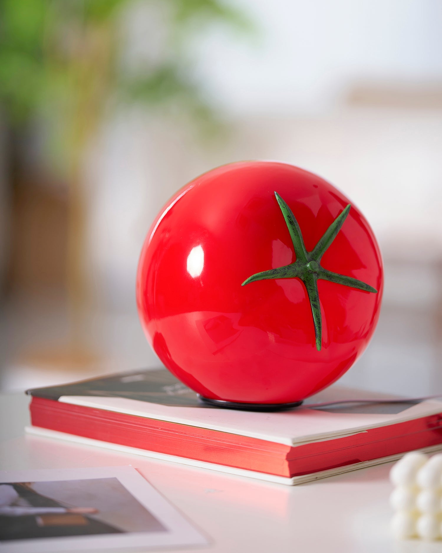 Tomato Glass Table Lamp illuminated in a styled interior