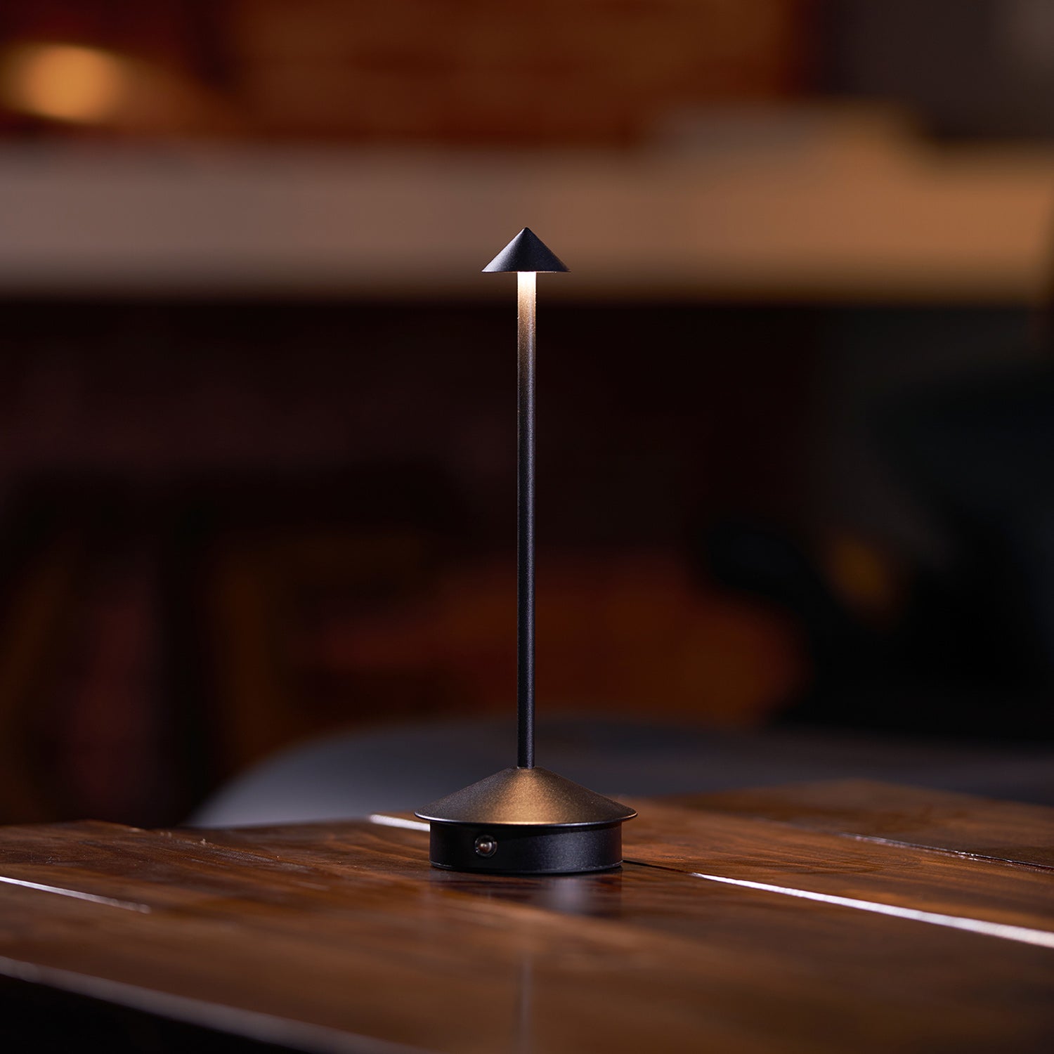 Pina rechargeable table lamp providing warm light